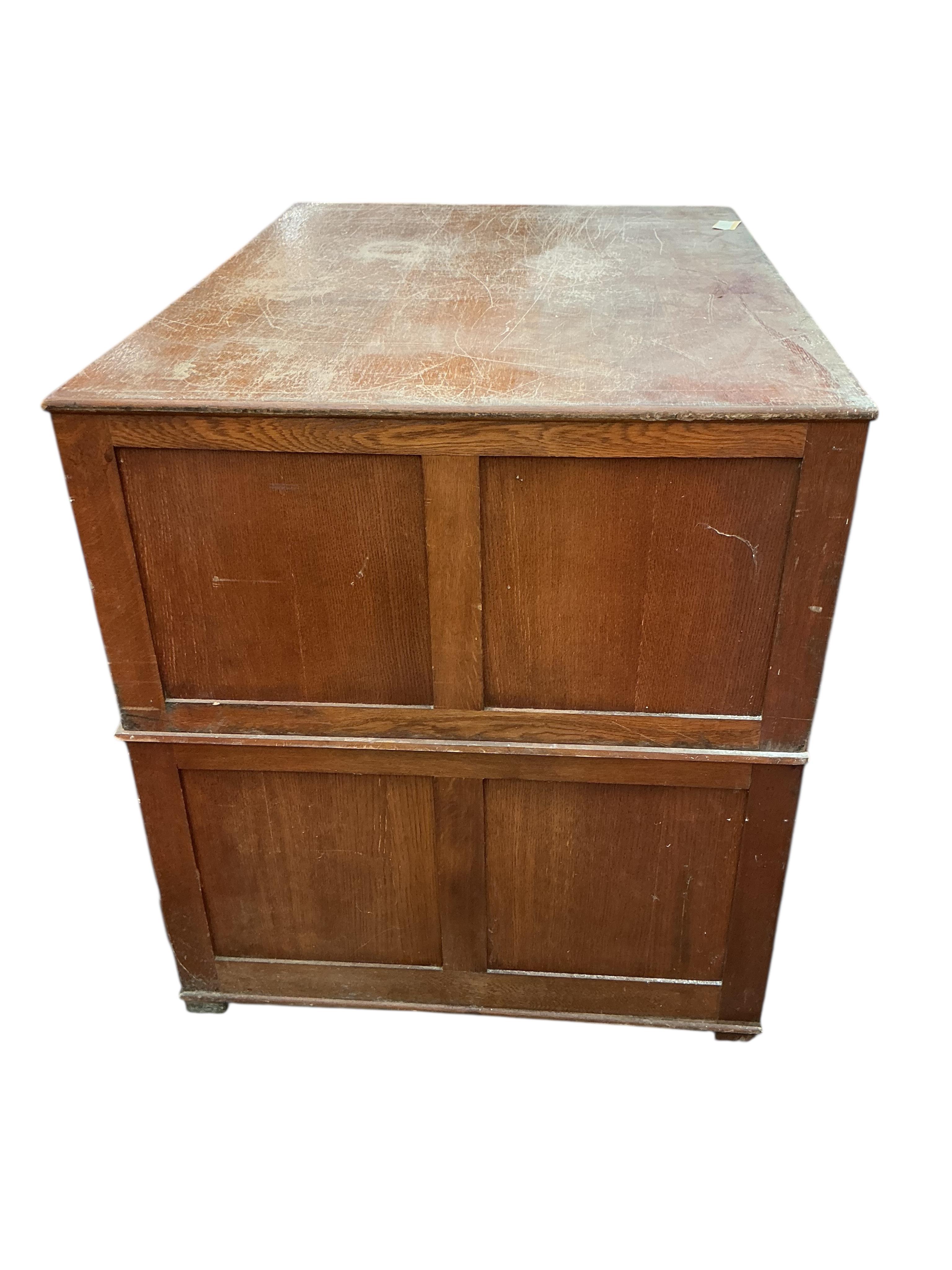 A 1930's light oak plan chest in two sections, width 113cm, depth 82cm, height 92cm